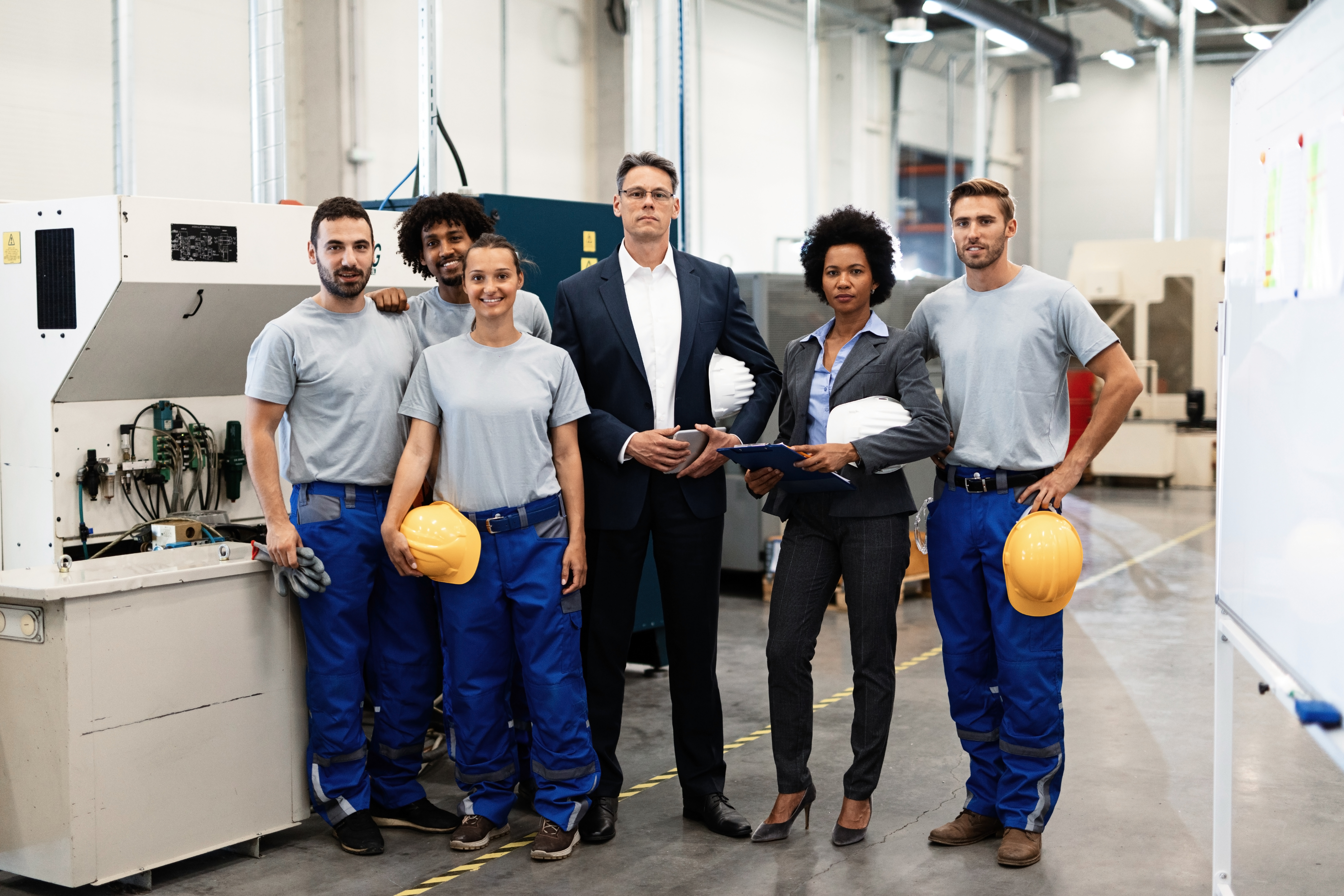 portrait-group-engineers-corporate-managers-standing-factory-looking-camera-1